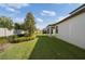 Green backyard featuring plush lawn, tidy landscaping, and covered patio at 3991 Mellon Dr, Odessa, FL 33556