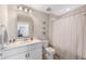 Bathroom with a toilet, shower with curtain, vanity and mirror at 3991 Mellon Dr, Odessa, FL 33556