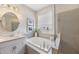 Relaxing bathroom featuring soaking tub, stylish decor, and a separate glass-enclosed shower at 3991 Mellon Dr, Odessa, FL 33556