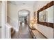 Inviting entryway with hardwood floors, decorative mirror, bench and stairway to the upper level at 3991 Mellon Dr, Odessa, FL 33556