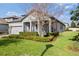 A well-manicured lawn and garden surround this beautiful home with a two-car garage at 3991 Mellon Dr, Odessa, FL 33556