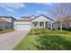 Inviting single-story home with a well-manicured front yard, covered porch, and brick-paved driveway at 3991 Mellon Dr, Odessa, FL 33556