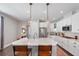 Modern kitchen featuring white cabinets, stainless steel appliances, quartz countertops and pendant lighting at 3991 Mellon Dr, Odessa, FL 33556