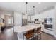 Bright kitchen featuring white cabinetry, stainless steel appliances, quartz countertops and a large kitchen island at 3991 Mellon Dr, Odessa, FL 33556