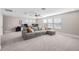 Spacious living room featuring a plush sectional sofa, a ceiling fan, and lots of natural light at 3991 Mellon Dr, Odessa, FL 33556