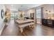 Bright living room featuring a dining table with bench seating and views of the backyard through sliding glass doors at 3991 Mellon Dr, Odessa, FL 33556