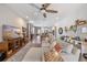 Spacious living room with comfortable sectional, shelving, and open view to kitchen and dining area at 3991 Mellon Dr, Odessa, FL 33556
