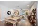 Open-concept living room with wood floors, dining table, and comfortable seating area with sliding glass door at 3991 Mellon Dr, Odessa, FL 33556