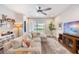 Comfortable living room with neutral sectional sofa, large windows, ceiling fan and access to the backyard at 3991 Mellon Dr, Odessa, FL 33556