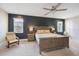 Comfortable main bedroom with large bed, accent wall, and lots of natural light from bright windows at 3991 Mellon Dr, Odessa, FL 33556