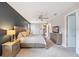 Cozy main bedroom with a dark accent wall, soft carpet, and a bright open door at 3991 Mellon Dr, Odessa, FL 33556