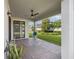 Outdoor patio with brick pavers, ceiling fan, and view of the backyard at 3991 Mellon Dr, Odessa, FL 33556