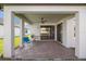 Covered patio with brick pavers, ceiling fan, and view of the well-kept backyard at 3991 Mellon Dr, Odessa, FL 33556