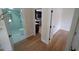 Hallway view of renovated bathroom and a modern kitchen at 4024 N Seminole Ave, Tampa, FL 33603