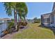 Landscaped backyard with canal views, privacy fence and screened in lanai at 413 Islebay Dr, Apollo Beach, FL 33572