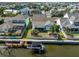Backyard aerial view featuring boat dock, boat lift, screened in lanai, and water access at 413 Islebay Dr, Apollo Beach, FL 33572