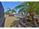 Waterfront backyard view with white fencing and lush landscaping, showcasing tranquil waterfront property at 413 Islebay Dr, Apollo Beach, FL 33572