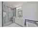 Luxurious bathroom featuring dual vanities, a walk-in shower, and blue accent tiles at 413 Islebay Dr, Apollo Beach, FL 33572