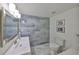 Modern bathroom featuring stylish blue tile accent wall, sleek fixtures, and contemporary design at 413 Islebay Dr, Apollo Beach, FL 33572