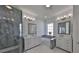 Luxurious bathroom featuring dual vanities, a soaking tub, and a glass-enclosed shower at 413 Islebay Dr, Apollo Beach, FL 33572