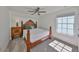 Cozy bedroom with wood-framed bed, soft carpet, and natural light from a window at 413 Islebay Dr, Apollo Beach, FL 33572
