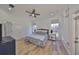 Bright bedroom featuring light hardwood floors, ceiling fan, and light blue accents at 413 Islebay Dr, Apollo Beach, FL 33572