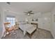 A cozy bedroom with a ceiling fan, a rocking chair, a comfortable bed, and lots of natural light at 413 Islebay Dr, Apollo Beach, FL 33572