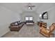 A large bonus room has plush carpeting, neutral paint, and a ceiling fan for extra comfort and relaxation at 413 Islebay Dr, Apollo Beach, FL 33572