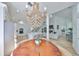 Bright, open-concept living space featuring an elegant chandelier, modern kitchen, and inviting dining area at 413 Islebay Dr, Apollo Beach, FL 33572