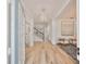 Inviting entryway featuring wood floors, contemporary lighting, and views of the staircase and living areas at 413 Islebay Dr, Apollo Beach, FL 33572