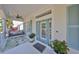 Inviting front porch with a swing, decorative front door, and beachy accents at 413 Islebay Dr, Apollo Beach, FL 33572