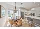 Open floor plan shows the modern kitchen with stainless appliances, flowing into the elegant dining area at 413 Islebay Dr, Apollo Beach, FL 33572