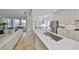 Contemporary kitchen with white countertops, stainless steel appliances, and a view of the spacious living area at 413 Islebay Dr, Apollo Beach, FL 33572