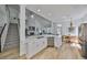 Open kitchen with sleek white cabinets, a large island, and views of the adjacent living and dining areas at 413 Islebay Dr, Apollo Beach, FL 33572