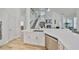 Modern kitchen featuring white countertops, stainless steel appliances, and open layout at 413 Islebay Dr, Apollo Beach, FL 33572