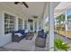 Comfortable lanai with ceiling fans, white support pillars, and ample seating perfect for relaxing outdoors at 413 Islebay Dr, Apollo Beach, FL 33572