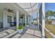 Spacious lanai with ceiling fans, white support pillars, and ample seating perfect for relaxing outdoors at 413 Islebay Dr, Apollo Beach, FL 33572