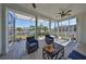 Inviting screened lanai with comfortable seating, ceiling fans, and views of canal at 413 Islebay Dr, Apollo Beach, FL 33572