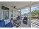 Relaxing outdoor space with comfortable seating, ceiling fans, and a view of tropical landscaping at 413 Islebay Dr, Apollo Beach, FL 33572