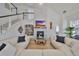 Open-concept living area with a marble fireplace, vaulted ceilings, and a staircase to the upper level at 413 Islebay Dr, Apollo Beach, FL 33572