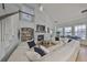 Open-concept living room with fireplace, white sectional sofa and vaulted ceilings at 413 Islebay Dr, Apollo Beach, FL 33572