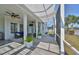 Spacious covered patio featuring ceiling fans and views of the lush backyard at 413 Islebay Dr, Apollo Beach, FL 33572