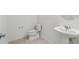 Powder room featuring pedestal sink, modern faucet, and tile floors at 4255 Big Sky Dr, Spring Hill, FL 34604