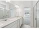 Modern bathroom with double sinks, white subway tile, and glass-enclosed shower at 4255 Big Sky Dr, Spring Hill, FL 34604