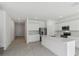 Bright, open kitchen featuring stainless steel appliances, white cabinets, and a large island at 4255 Big Sky Dr, Spring Hill, FL 34604