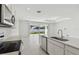 Modern kitchen featuring stainless steel appliances and sleek countertops with access to the backyard at 4255 Big Sky Dr, Spring Hill, FL 34604