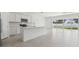 Spacious kitchen with modern appliances, a large island, and abundant natural light shining through sliding doors at 4255 Big Sky Dr, Spring Hill, FL 34604