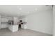 Spacious eat-in kitchen featuring stainless appliances, white cabinets, and a large island at 4255 Big Sky Dr, Spring Hill, FL 34604