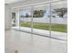 Living room featuring sliding glass doors providing ample natural light and views of the backyard at 4255 Big Sky Dr, Spring Hill, FL 34604