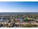 An aerial view of a house near a tranquil lake in a leafy neighborhood at 4322 22Nd N Ave, St Petersburg, FL 33713